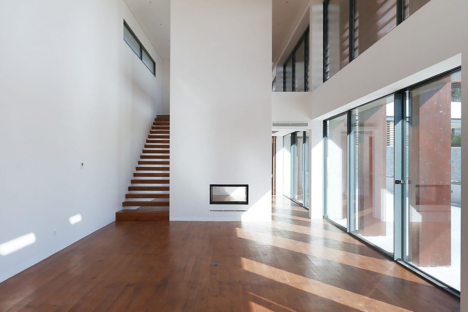 Spacious villa interior with floor-to-ceiling windows and contemporary design.