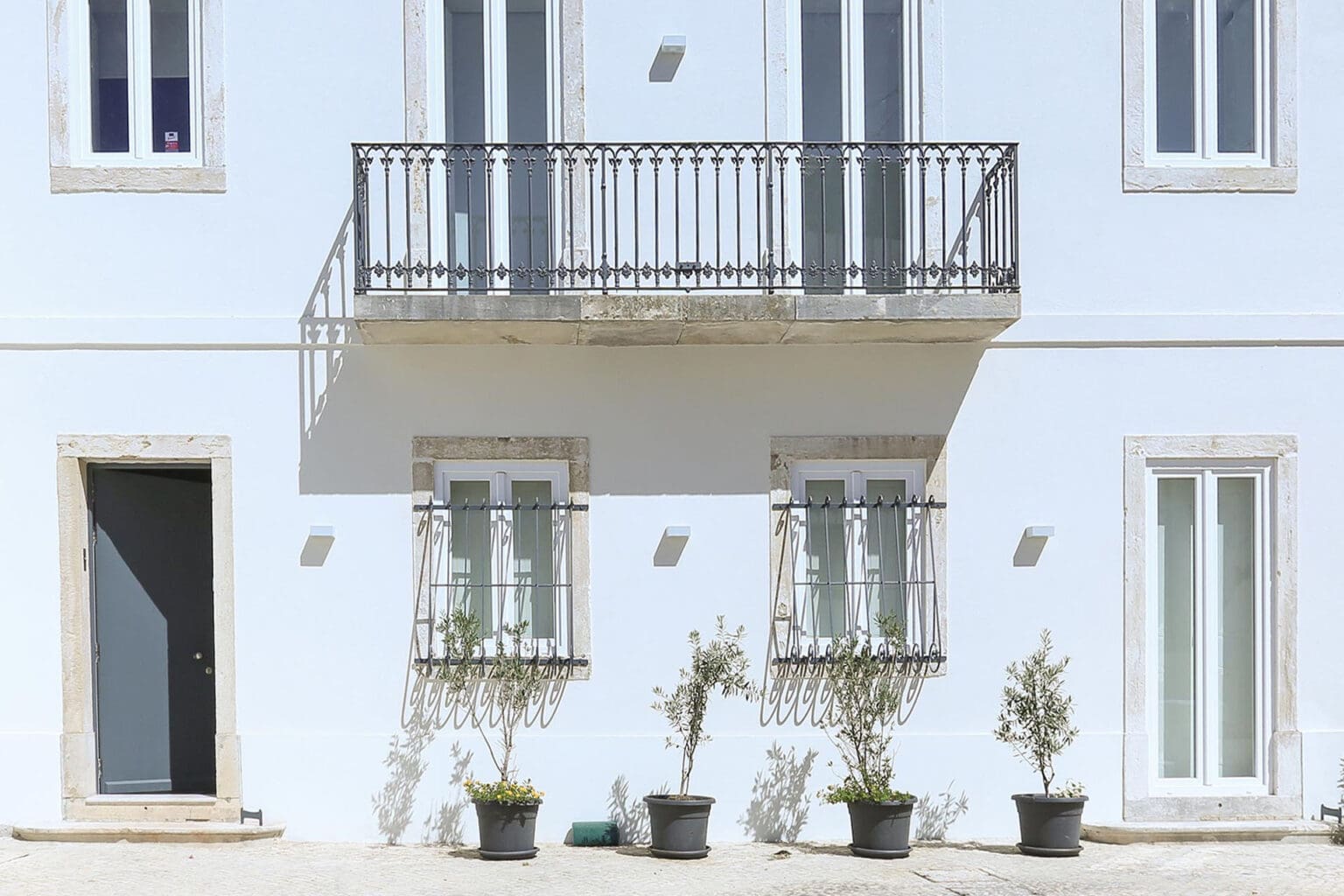Residential Home in Ajuda with Balcony and Potted Plants.
