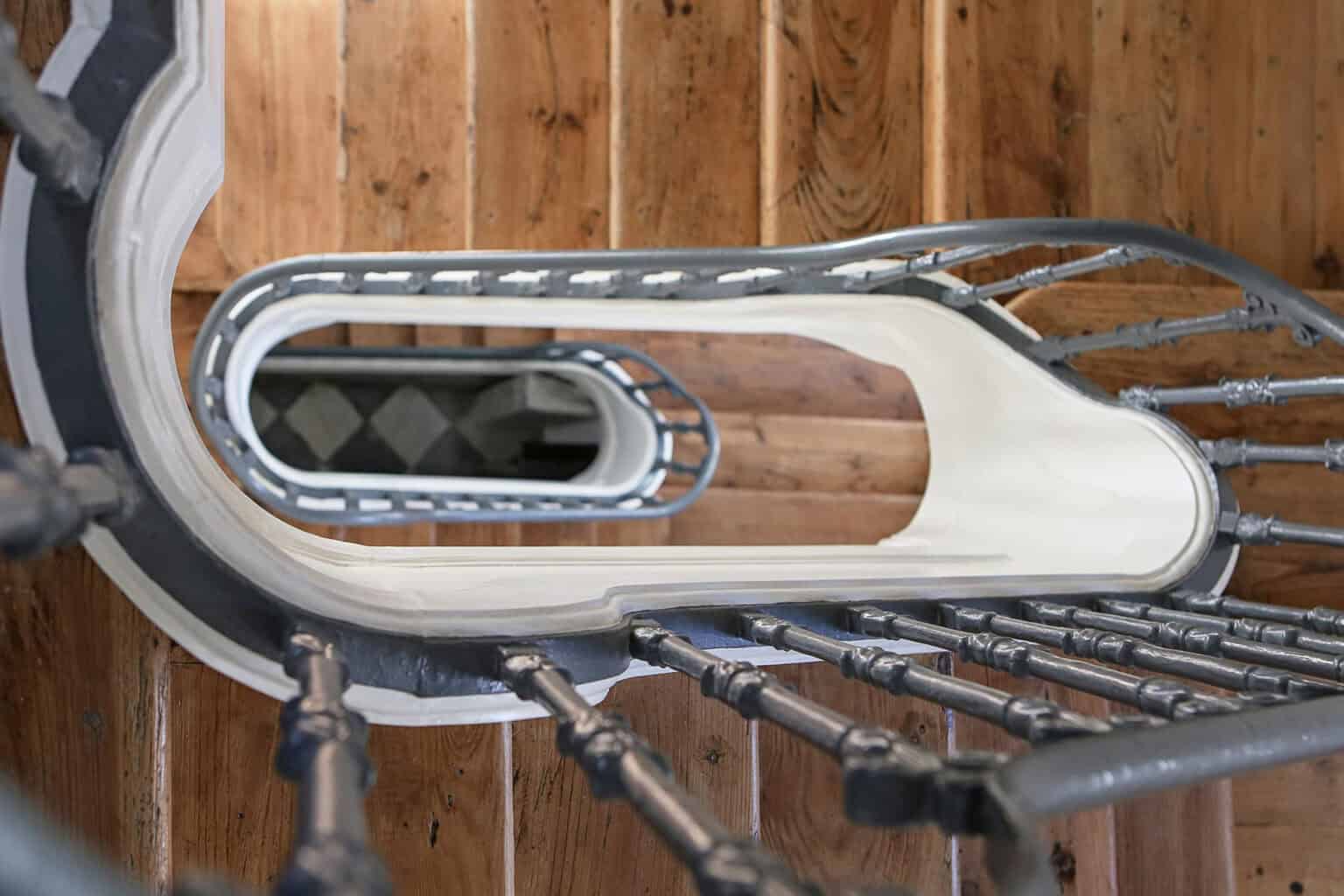 Residential staircase with wooden steps and metal railing in Ajuda, Lisbon.